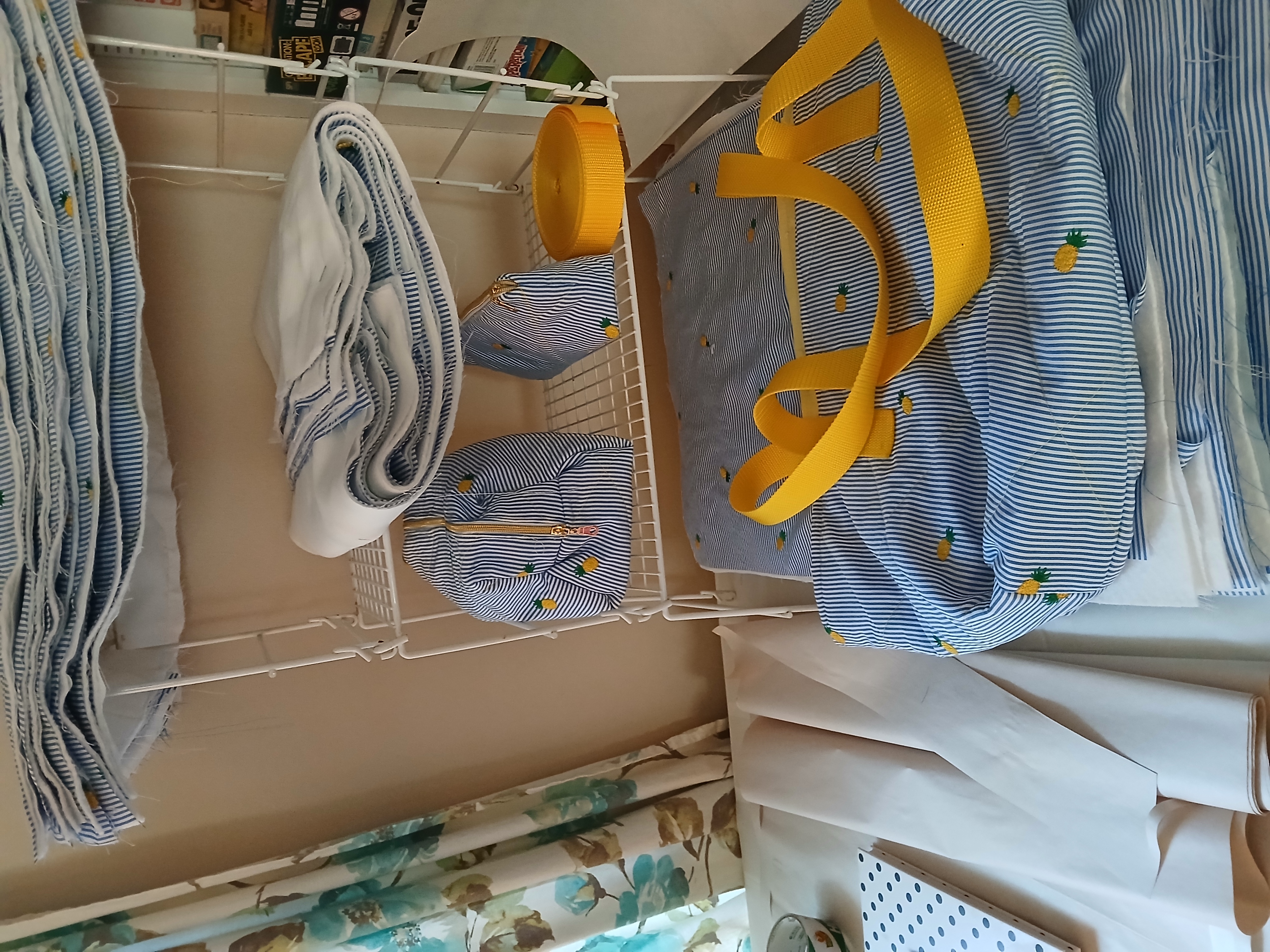 Blue striped tote bags with yellow handles displayed on a shelf